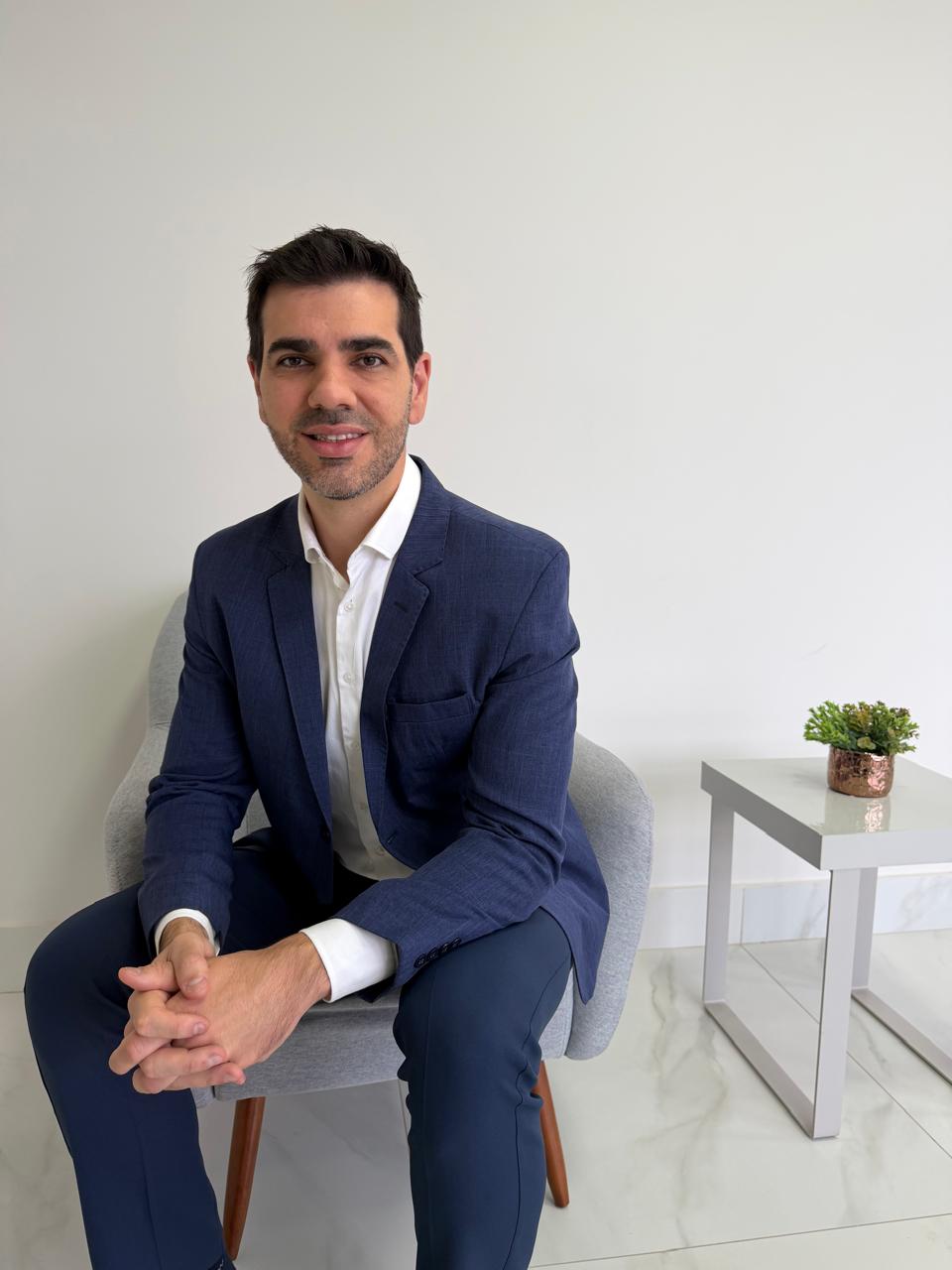 Dr. Victor Machado sentado no consultório