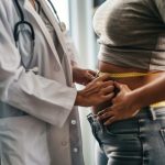 Measuring waist of overweight woman, female doctor with measuring tape in clinic measures the waist circumference, generative ai illustration