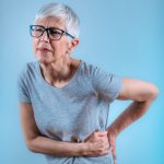 Sciatica. Senior woman with sciatic nerve pain in her lower back.